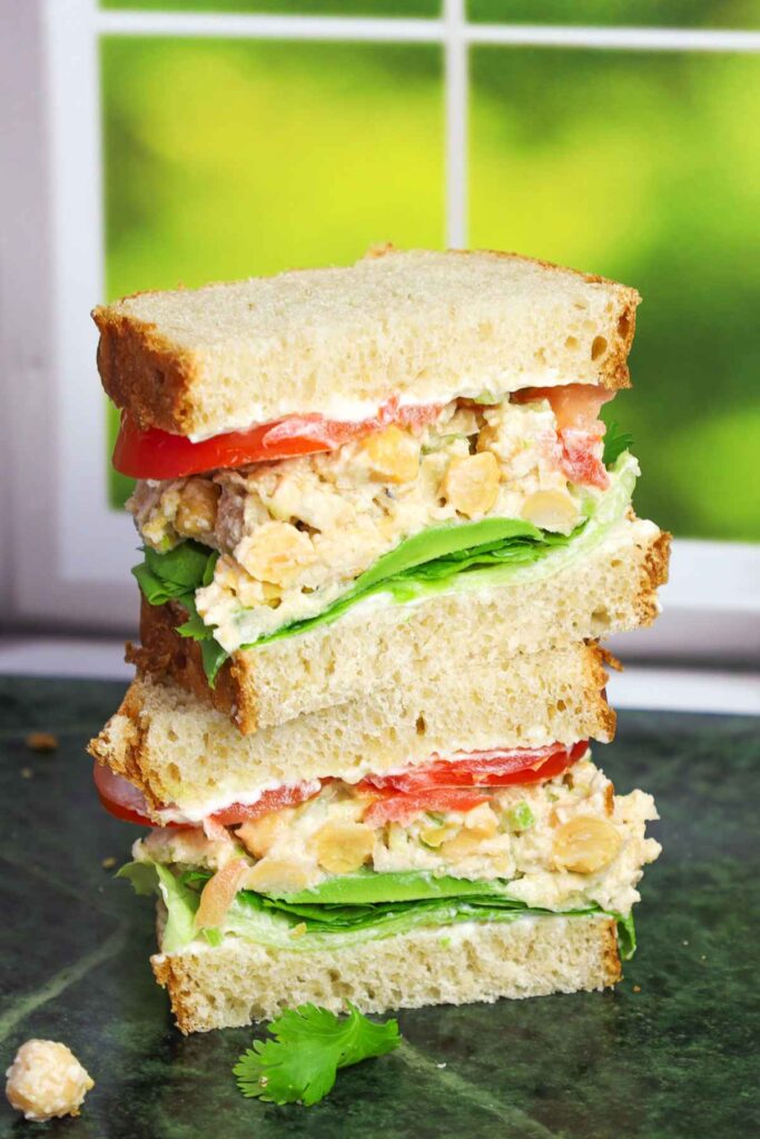 Chickpea Salad Sandwich cut in half and stacked on top of each other.
