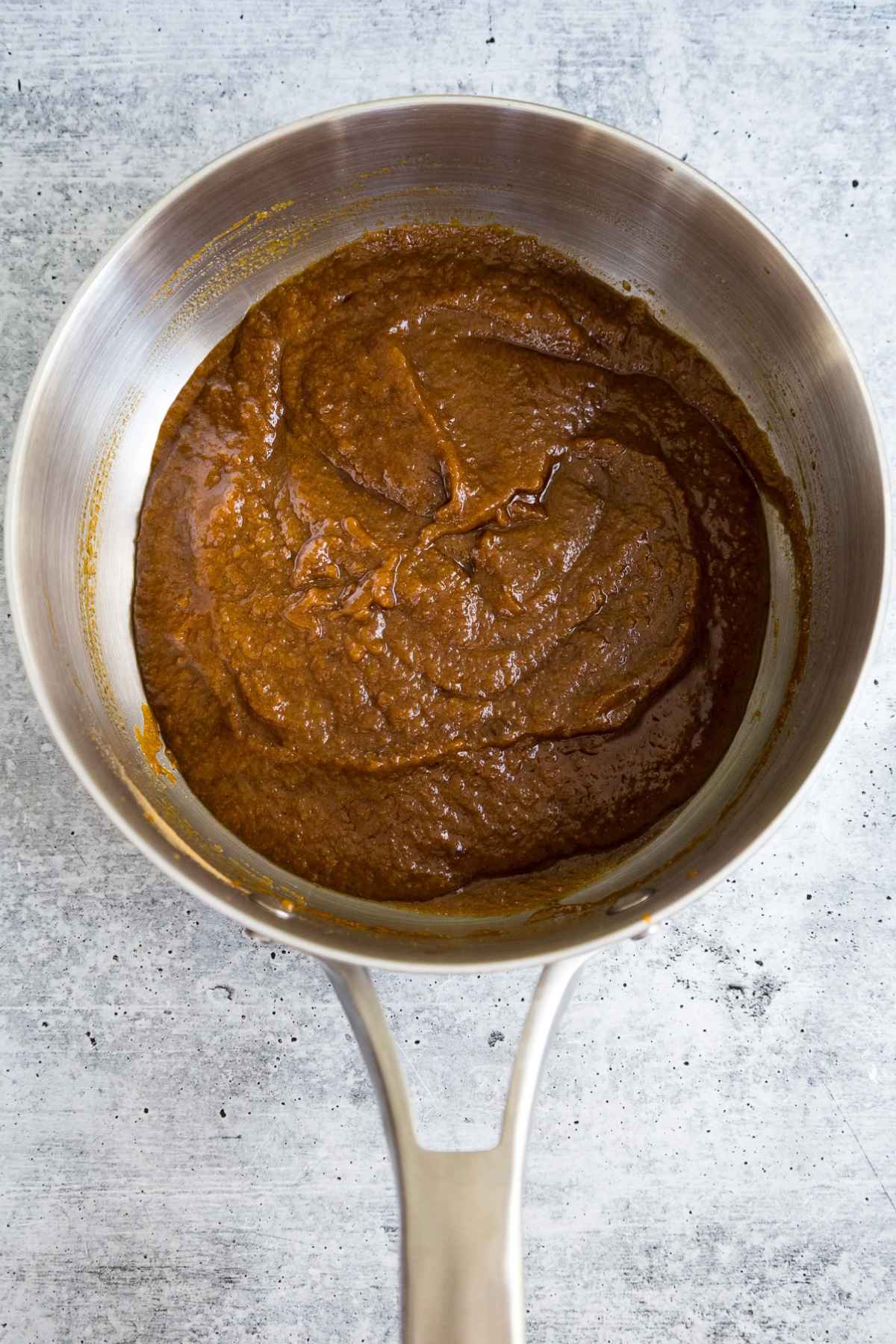 Cooked pumpkin mixture in a saucepan.
